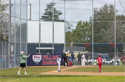 Youth baseball game in progress at a Long Beach Little League field